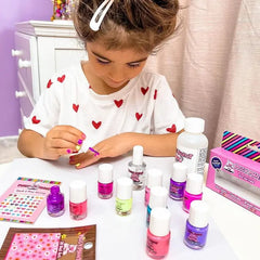 Child painting nails with Nail Polish Fairy Berry water-based, non-toxic, cruelty-free, and vegan nail polish set.