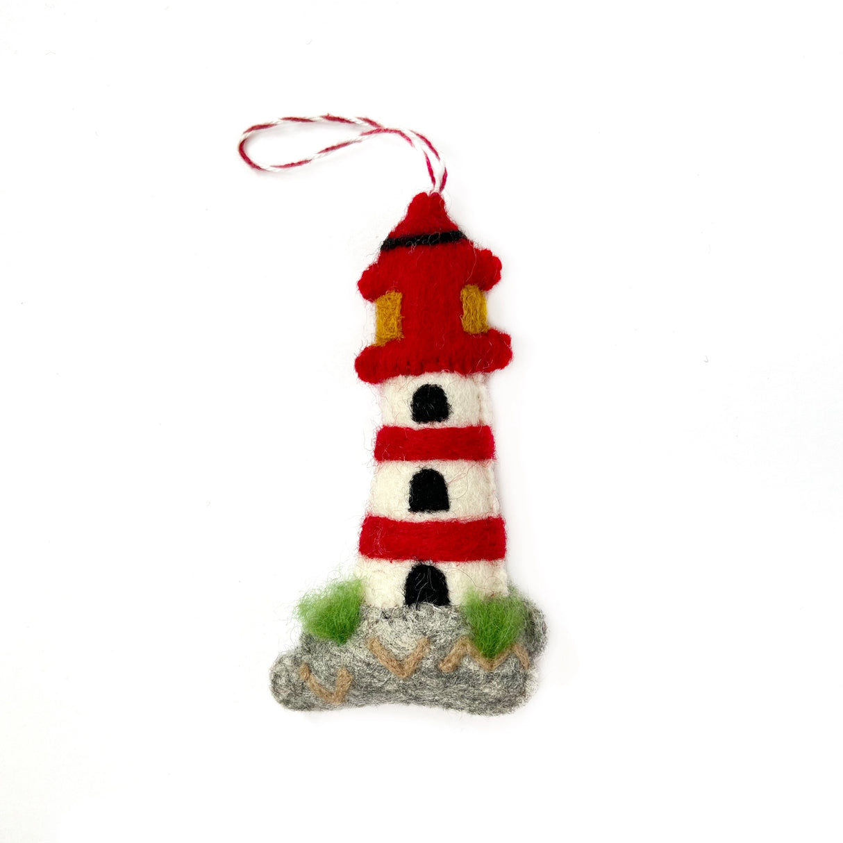 Handmade felt lighthouse ornament in red and white with green accents, perfect for whimsical holiday decor and gifting