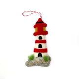 Handmade felt lighthouse ornament in red and white with green accents, perfect for whimsical holiday decor and gifting