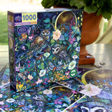 1000-piece puzzle box showing two owls perched in a lush garden under a glowing crescent moon among vibrant flowers and butterflies