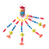 Squigz Mini colorful suction construction pieces arranged around a clear storage cup