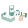 Miniature dollhouse bathroom set with bathtub, sink, toilet, towel rack, and laundry basket in soft pastel colors.