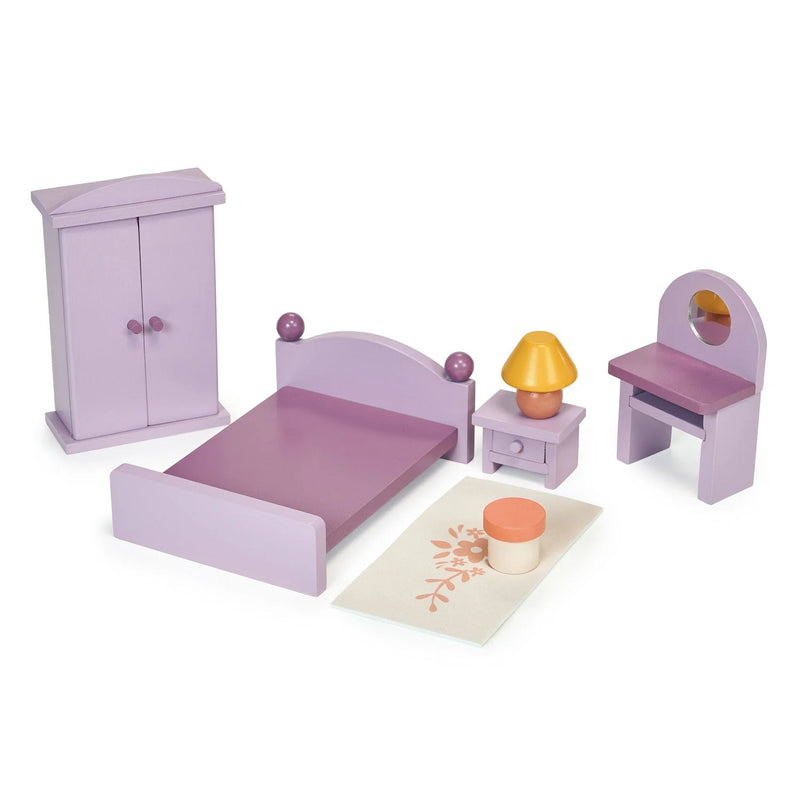 Wooden dollhouse bedroom set with purple bed, wardrobe, bedside table with lamp, dressing table, stool, and printed rug