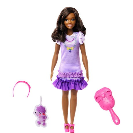 My First Barbie Black Hair doll in lilac dress with polka dot sleeves, headband, pink shoes, and accessory set.