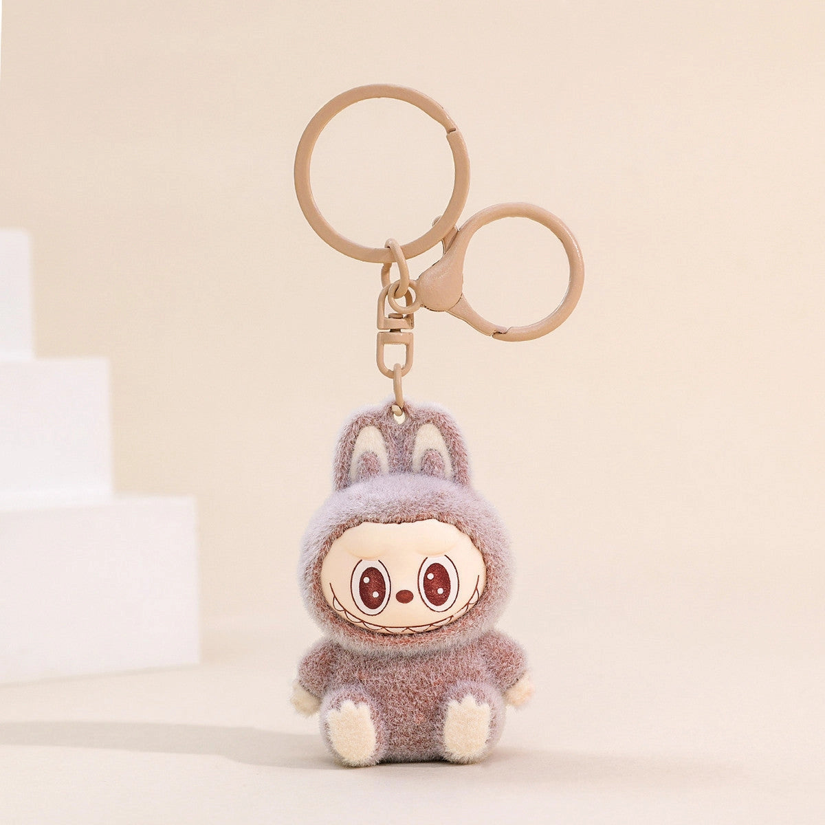 Labubu Flocking Keychain with fuzzy texture and playful smile, a lightweight and cheerful accessory for your keys.