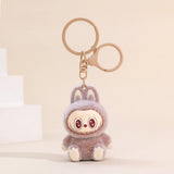 Labubu Flocking Keychain with fuzzy texture and playful smile, a lightweight and cheerful accessory for your keys.