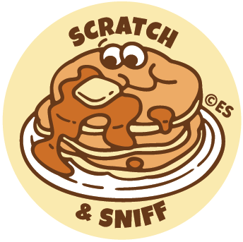 Round sticker showing a stack of pancakes with syrup and butter, labeled Scratch & Sniff on a cream background