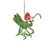 Green felt Christmas cricket ornament wearing a red Santa hat hanging by a green string on white background