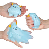 Blue squishy toy characters with yellow horns being stretched and squeezed in hands