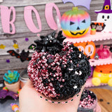 Cursed But Cute Crunchy Slime in pink and black with a cute bat charm and Halloween themed sprinkles