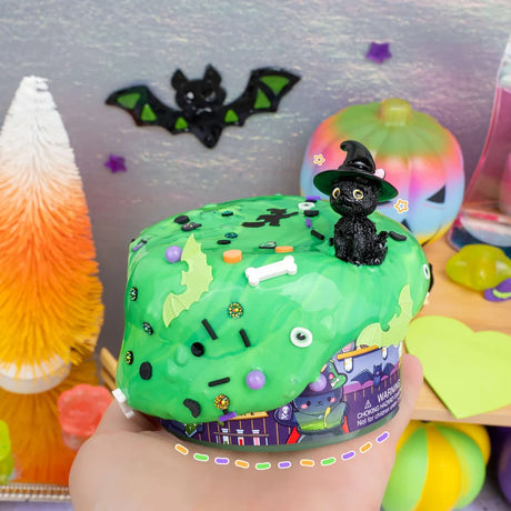 Curious Cat Workshop Slime tub with green slime black sprinkles and a witch cat figure