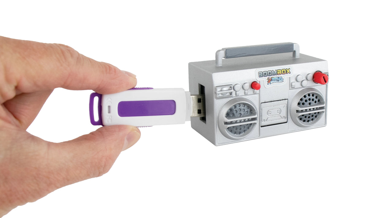 Hand inserting white and purple USB drive into small gray toy boombox with red and white details against white background