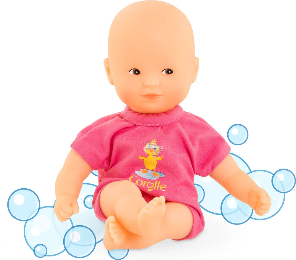 Soft-touch pink baby doll in a pink shirt with floating limbs surrounded by playful water bubbles