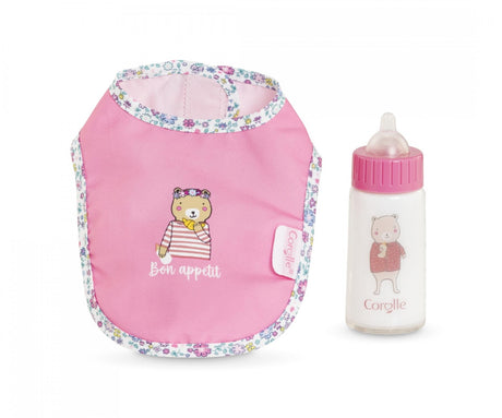 Pink baby bib with floral trim and bear design next to matching baby bottle with bear illustration and pink cap