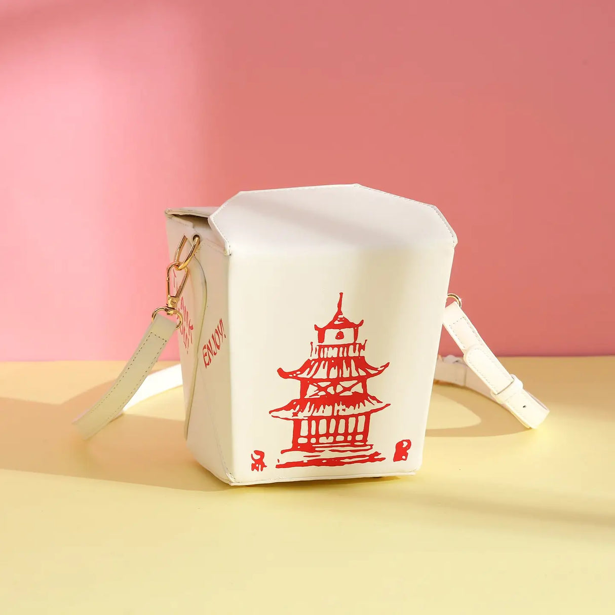 Handbag | Takeout Box white crossbody bag shaped like a Chinese takeout box with red pagoda design and adjustable strap.