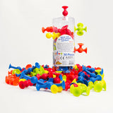 Squigz Mini colorful connecting suction toys in and around a clear container