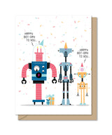 Quad fold birthday card with three colorful robots celebrating with party hats and confetti on a white background