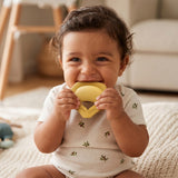 Ciao Down Tortellini Teether chewed by a smiling baby