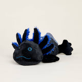 Soft plush black axolotl with blue accents scented with lavender for comforting warmth and sensory relief