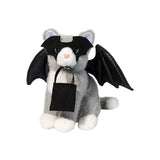 Plush gray and white cat wearing a bat mask and wings holding a small black felt treat bag for Halloween.