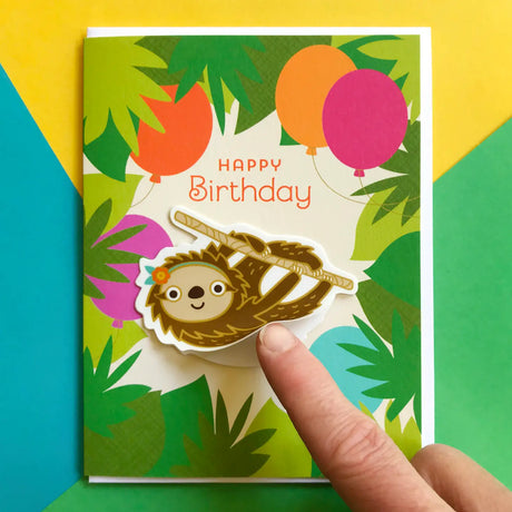 Forest Sloth Birthday Sticker Card featuring a happy sloth vinyl sticker on a colorful jungle birthday card.