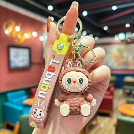 Labubu Silicone Keychain featuring a cute, brown character with a playful design and durable silicone strap held in hand.