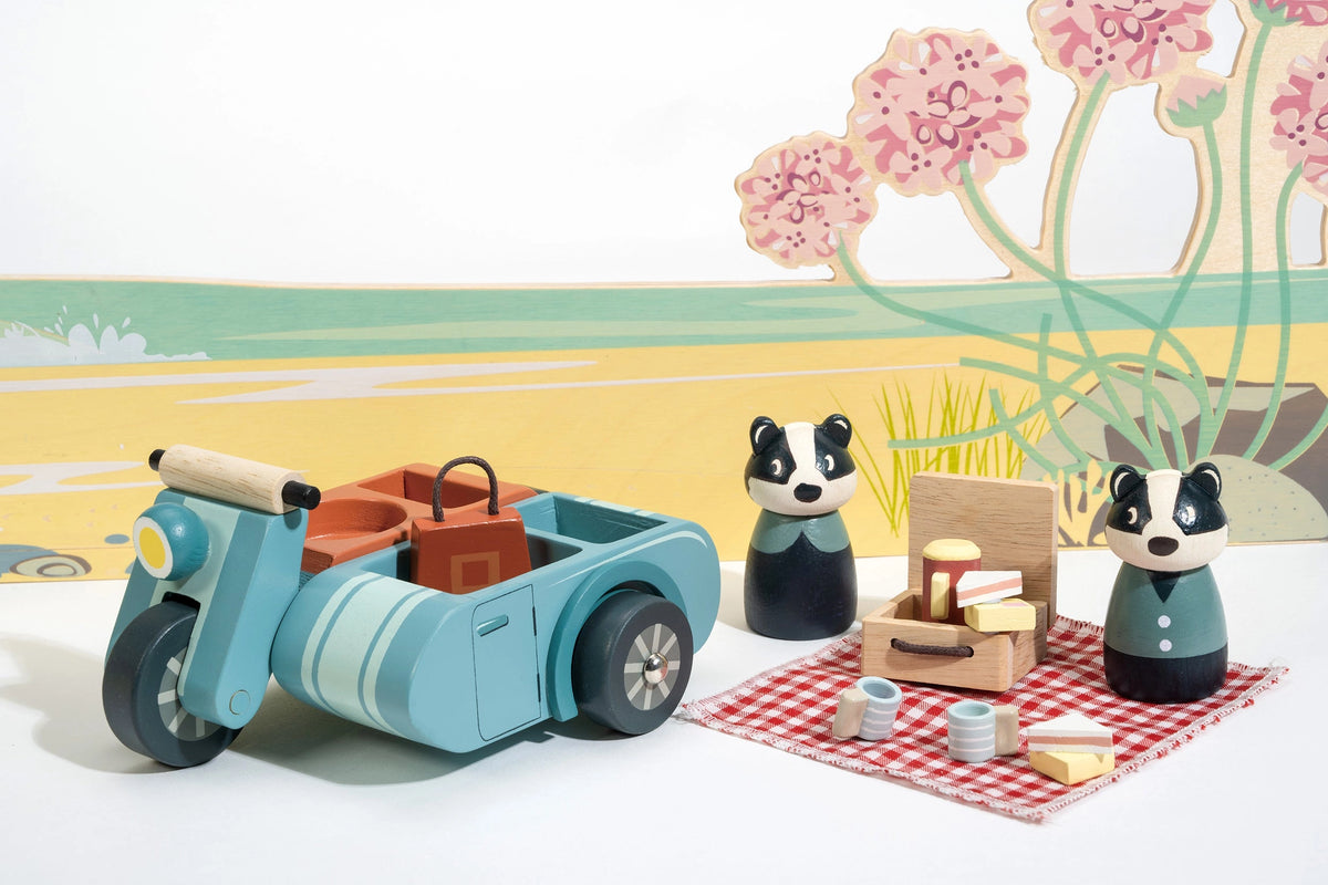 Badger Picnic Motorbike Ride with two badger figures beside a blue motorbike sidecar and picnic tea set