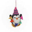 Cute felt penguin ornament wearing a striped party hat and holding colorful felt flags, hanging by a string