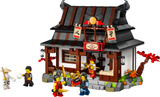 Ninjago blacksmith shop building set with detailed forge, bedroom interior, and four minifigures posed around the model.