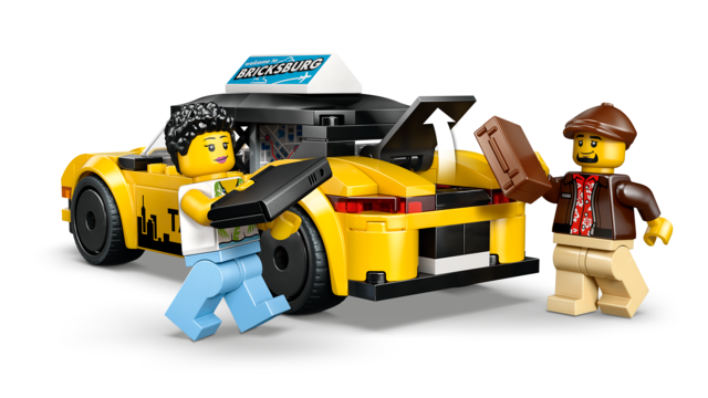 Toy model of a yellow taxi with open trunk and two minifigures loading luggage for pretend play