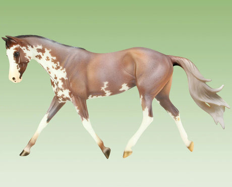 Full Moon Rising model horse in mid-stride, showcasing detailed paint and realistic Thoroughbred features.