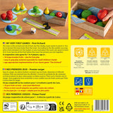 Wooden fruit basket game set with colorful fruits, raven figure, game board pieces, and dice for cooperative play