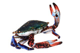 Crab with a colorful blue red and green shell and raised claw