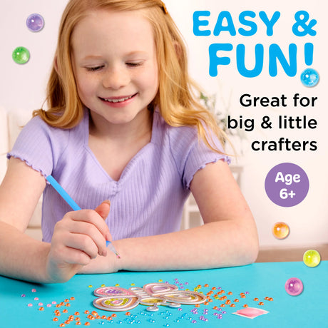 Child happily creating a Butterfly with Bubble Gems Super Sticker Butterfly diamond painting craft, age 6+ activity.