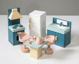 Wooden dollhouse kitchen set with stove, refrigerator, sink, table, chairs, and tea set in soft pastel colors.