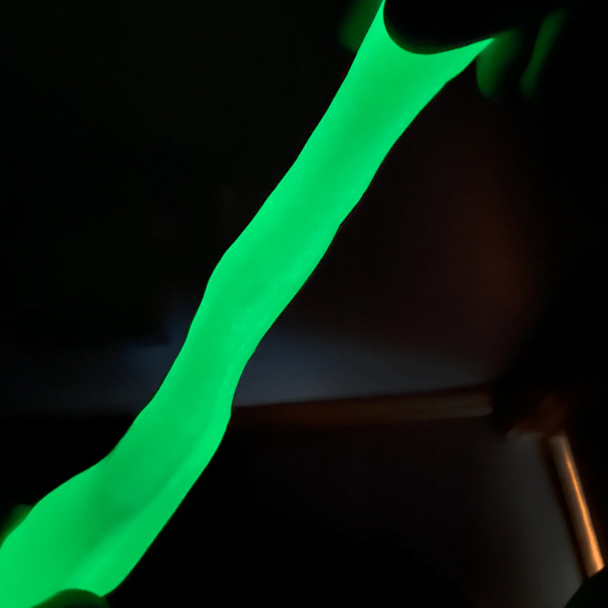 Gootonium: Glowing Brilliant Green Putty stretched and glowing brightly in the dark
