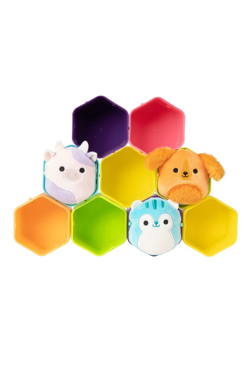 Three plush Micromallows toys displayed with colorful hexagonal capsule containers on a white background