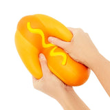 The Big Squij Hot Dog orange squishy toy with yellow mustard detail held in hands