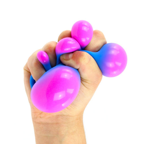 Color Change Super Squidgy Ball held in a hand with bright pink and blue colors