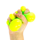 Color Change Super Squidgy Ball squeezed in hand with bright neon yellow green bubbles
