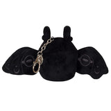 Plush micro moth-like creature viewed from behind with spread black wings and attached metal keychain clasp