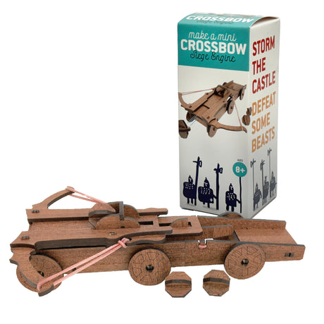 Mini wooden crossbow model kit with rubber bands and projectiles next to tall product box for kids ages eight and up