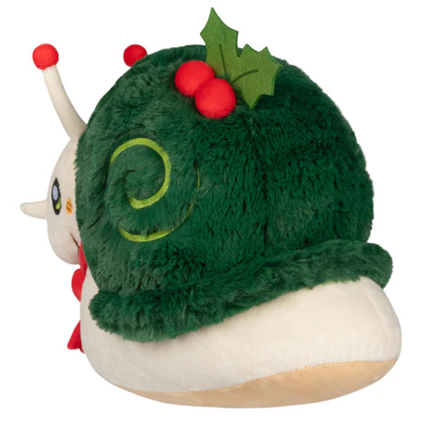 Plush white snail with dark green fuzzy shell decorated with holly leaves and red berry accents viewed from back