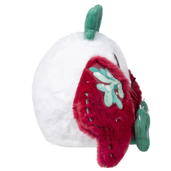 Plush white figure with bright green antlers and soft red wings decorated with green and white mistletoe embroidery