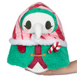 Plush figure with white beak mask, green fuzzy cloak, red striped hood, and candy cane accessory held in hand