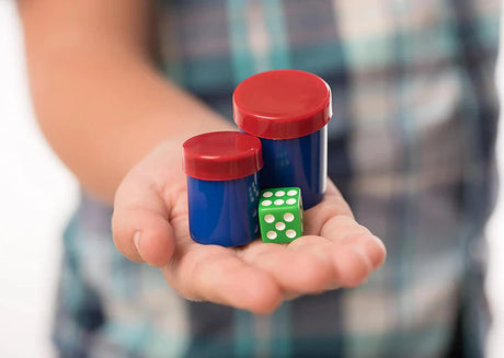 Child holding magic props including canisters and dice from Marvin's Magic Made Easy Amazing Tricks set for beginners and kids.