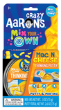 Crazy Aaron's Mix Your Own Mac N Cheese Thinking Putty kit with putty and mix-in pieces shown in packaging