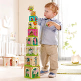 Toddler stacking colorful farm-themed cubes featuring animals and farm scenes in a bright, cozy playroom.