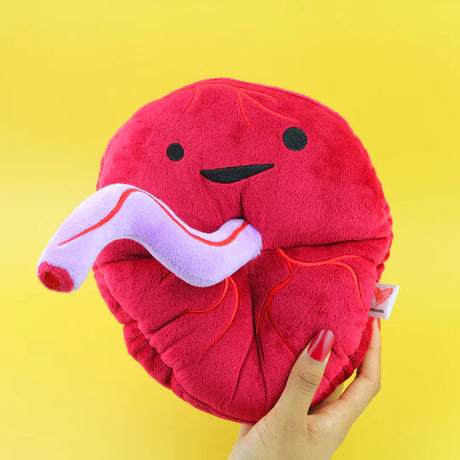 Handheld Placenta plush with a smiling face, red fabric, and soft purple umbilical cord on a yellow background.