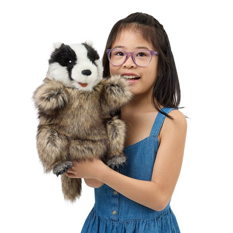 Badger Puppet held by a smiling child